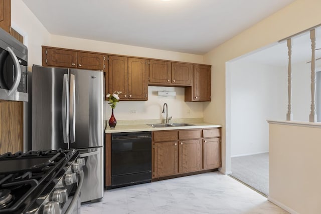 kitchen featuring light colored carpet, sink, and appliances with stainless steel finishes