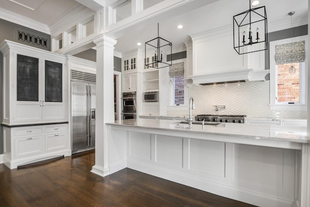 kitchen featuring white cabinetry, sink, hanging light fixtures, crown molding, and appliances with stainless steel finishes