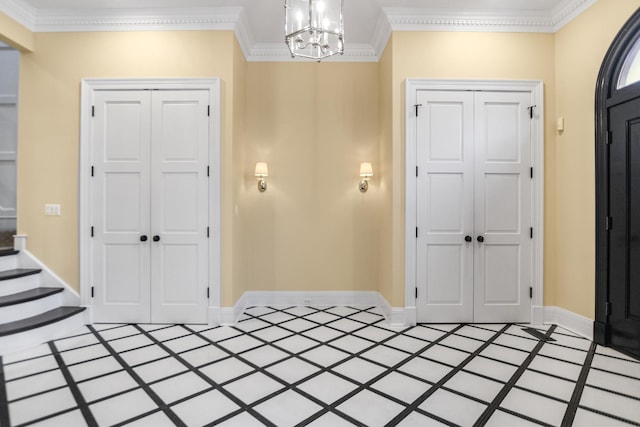 entryway featuring tile patterned flooring, an inviting chandelier, and ornamental molding