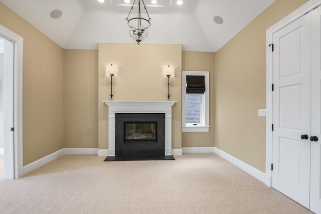 unfurnished living room with carpet flooring, an inviting chandelier, and lofted ceiling