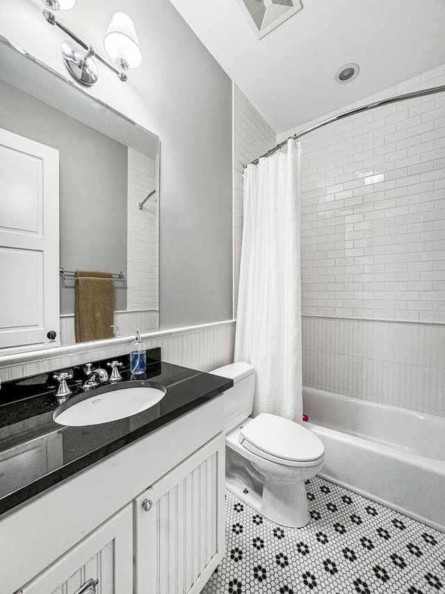 full bathroom with tile patterned floors, vanity, shower / tub combo, and toilet