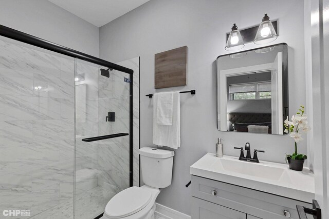 bathroom with vanity, toilet, and a shower with door