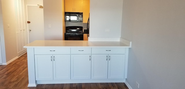 kitchen featuring white cabinets, kitchen peninsula, dark wood-type flooring, and black appliances