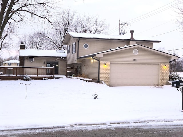 view of property featuring a garage and a deck