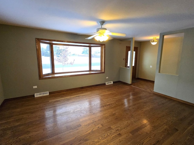 spare room featuring dark hardwood / wood-style flooring and ceiling fan