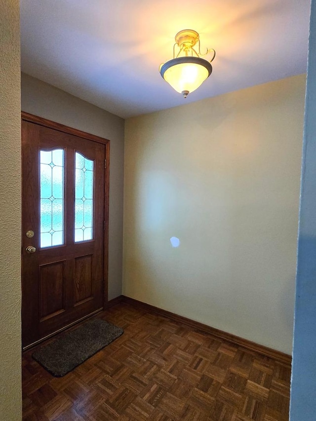 foyer with dark parquet floors