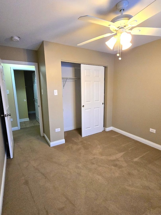 unfurnished bedroom featuring carpet flooring, a closet, and ceiling fan