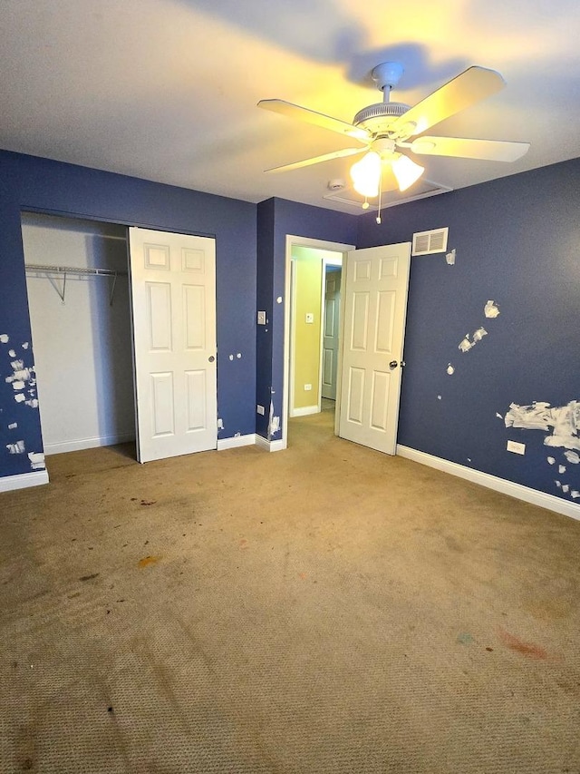 unfurnished bedroom with carpet, ceiling fan, and a closet