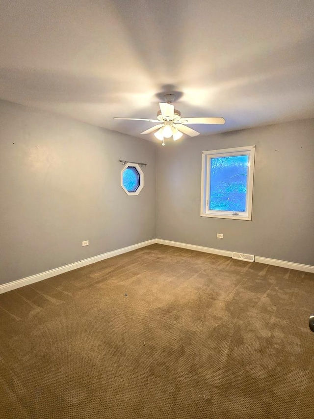 carpeted empty room featuring ceiling fan