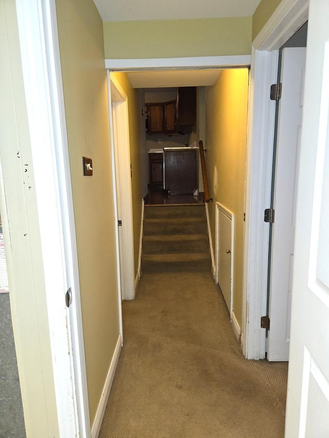 hall with light colored carpet