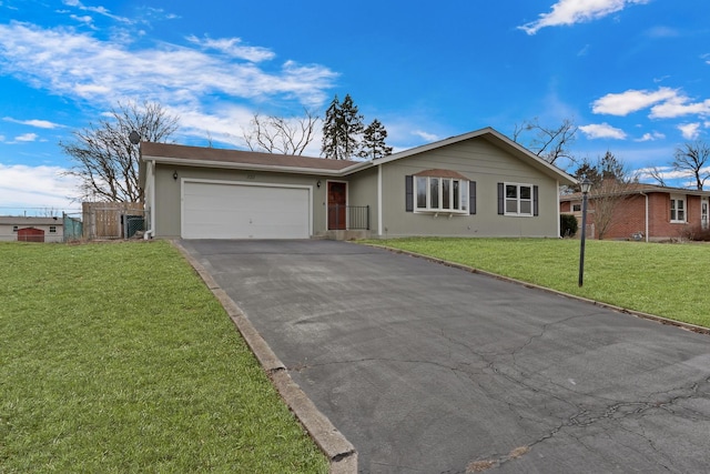 ranch-style home featuring a garage and a front lawn