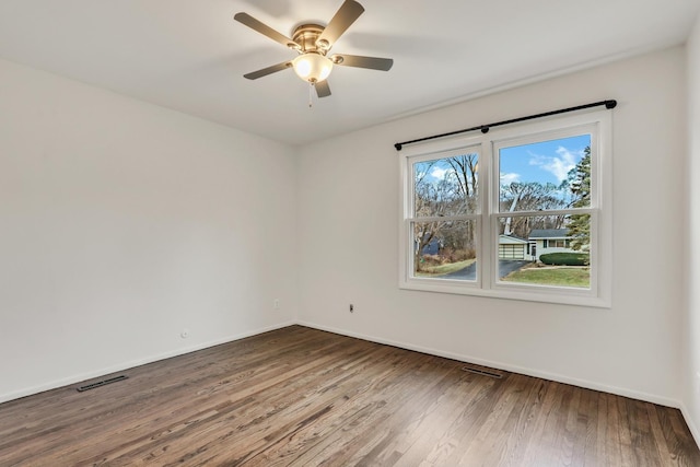 spare room featuring hardwood / wood-style floors and ceiling fan