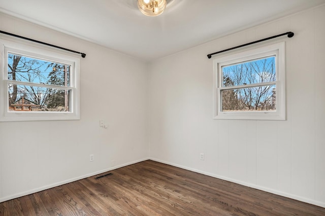 empty room featuring dark wood-type flooring