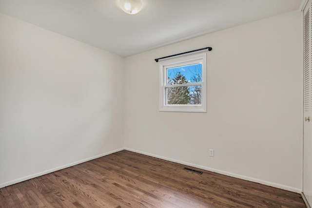 unfurnished room with hardwood / wood-style flooring