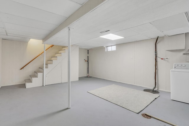 basement with washer / dryer and a drop ceiling