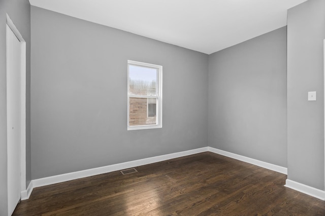 empty room featuring dark wood-type flooring