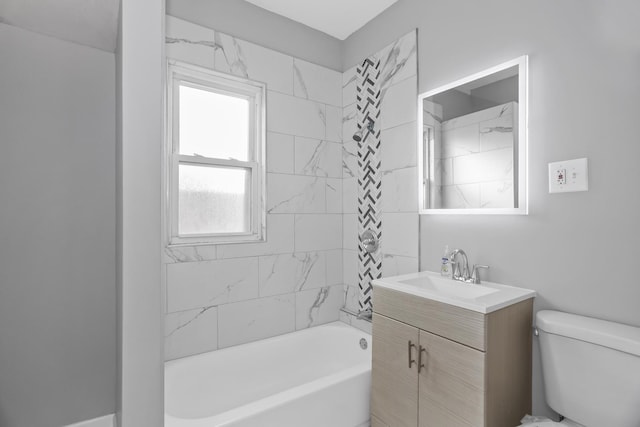 full bathroom featuring vanity, toilet, and tiled shower / bath combo