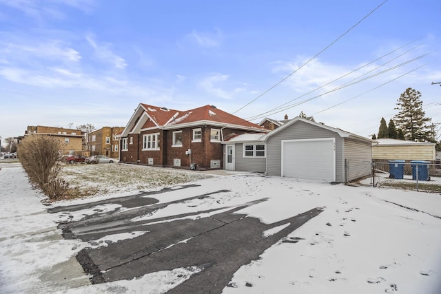 ranch-style home with an outbuilding and a garage