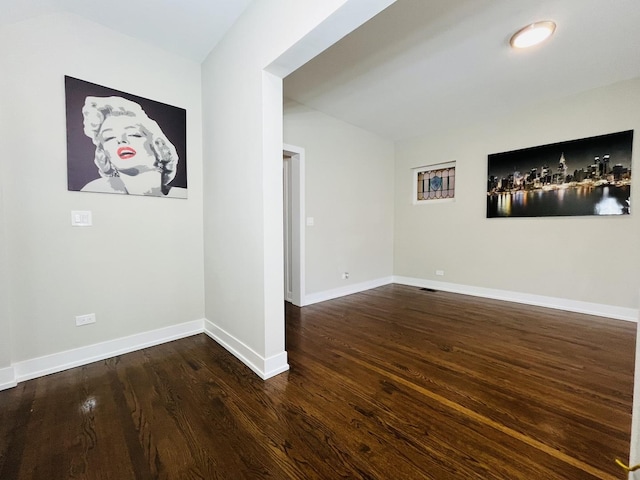 spare room featuring wood finished floors and baseboards