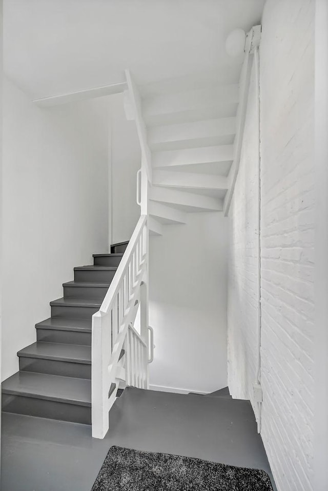 stairs with concrete flooring