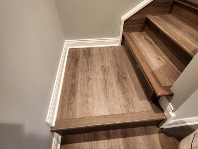 stairway featuring hardwood / wood-style flooring