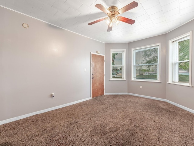 empty room featuring carpet flooring and ceiling fan