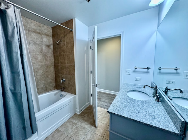 bathroom featuring tile patterned flooring, vanity, and shower / bathtub combination with curtain