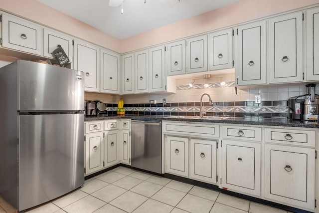 kitchen with appliances with stainless steel finishes, tasteful backsplash, light tile patterned floors, and sink