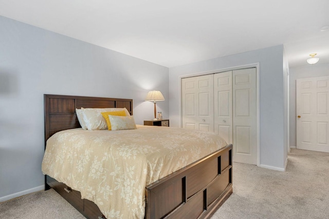 bedroom featuring light carpet and a closet