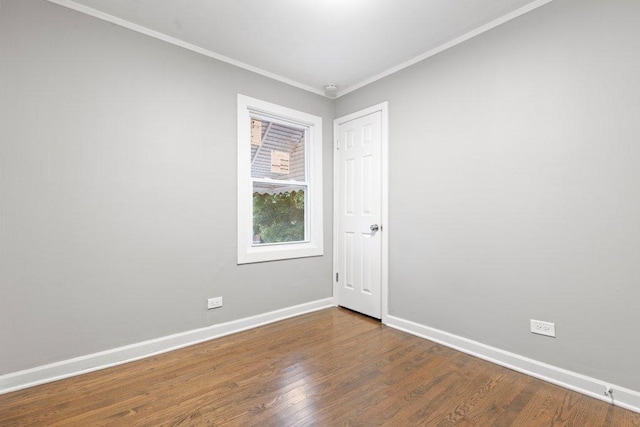 spare room featuring hardwood / wood-style flooring and ornamental molding