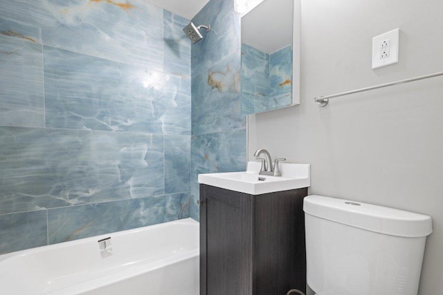 full bathroom featuring vanity, toilet, and tiled shower / bath