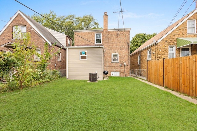 rear view of property with a yard