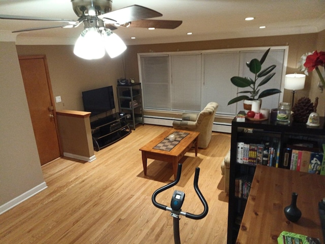 living room with ceiling fan, light hardwood / wood-style flooring, and a baseboard heating unit