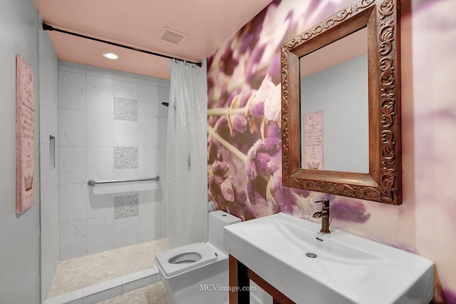 bathroom featuring vanity, toilet, and curtained shower