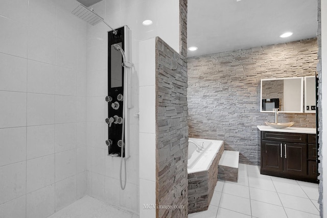 bathroom with vanity, tile walls, tile patterned floors, and plus walk in shower