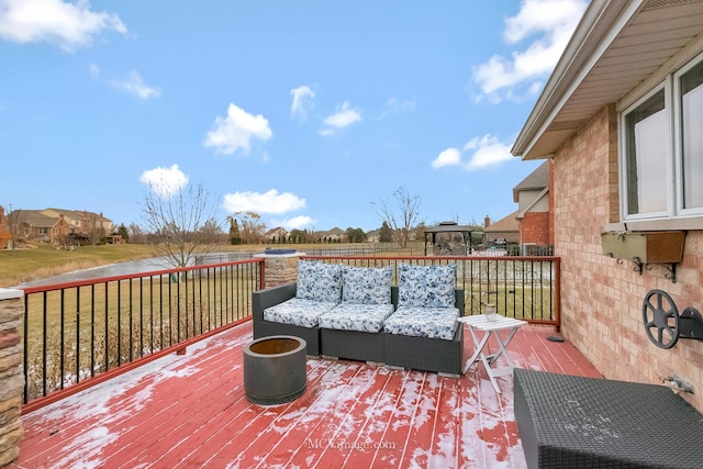 wooden terrace featuring an outdoor living space, a yard, and a gazebo