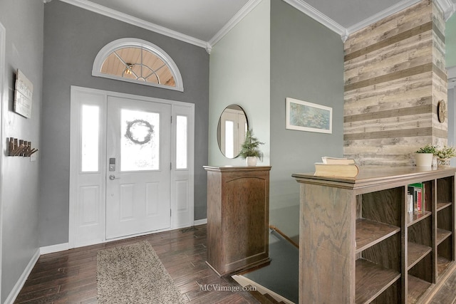 foyer entrance with a towering ceiling, ornamental molding, and dark hardwood / wood-style floors