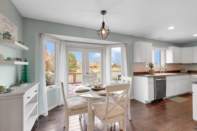 dining space with sink, dark wood-type flooring, and french doors