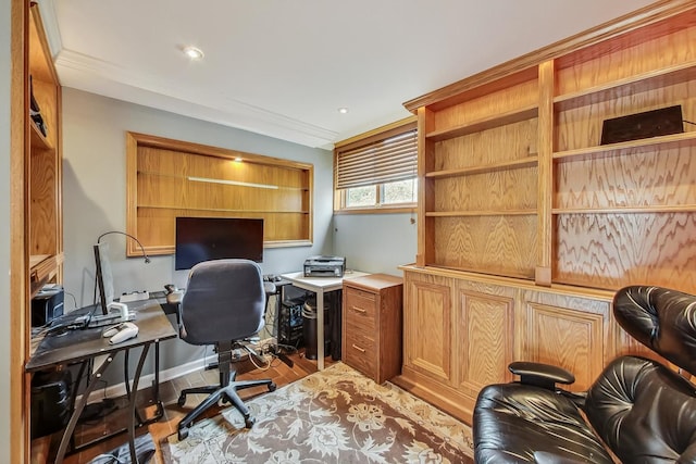 home office with light hardwood / wood-style flooring and ornamental molding