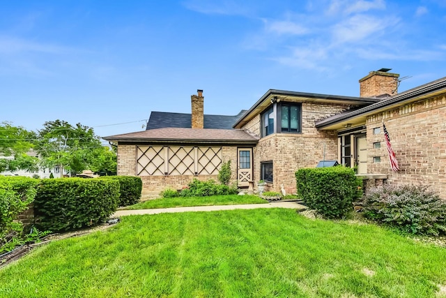 rear view of house with a yard