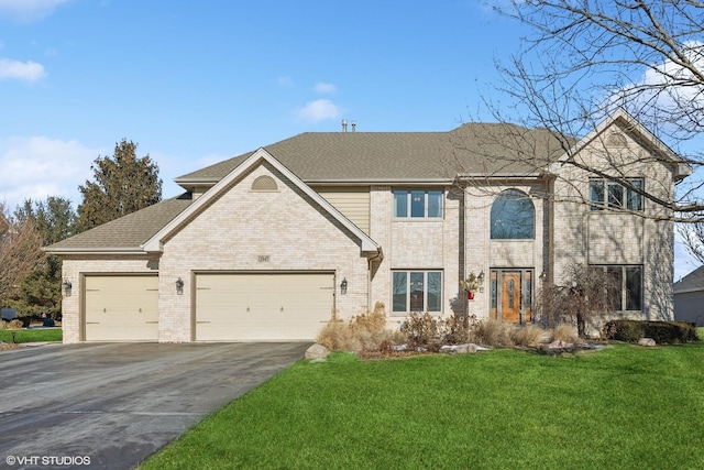 view of front of property featuring a garage and a front yard