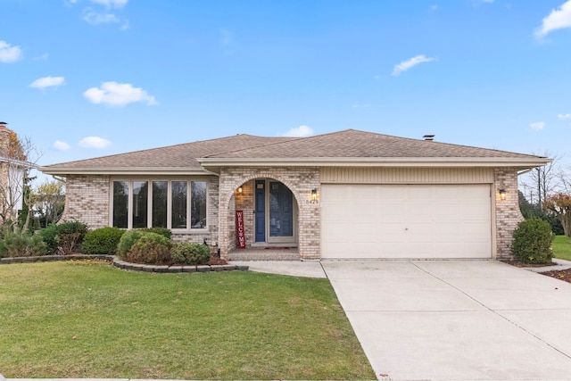 ranch-style home featuring a front lawn and a garage