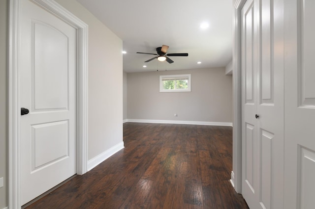 empty room with ceiling fan and dark wood-type flooring