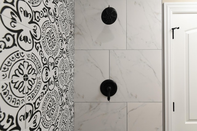 interior details featuring tiled shower