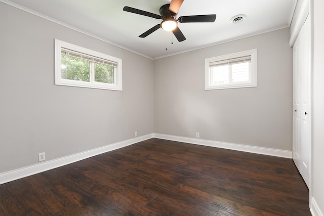 unfurnished room featuring dark hardwood / wood-style flooring, ceiling fan, and ornamental molding