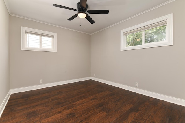 empty room featuring ornamental molding, ceiling fan, and dark wood-type flooring