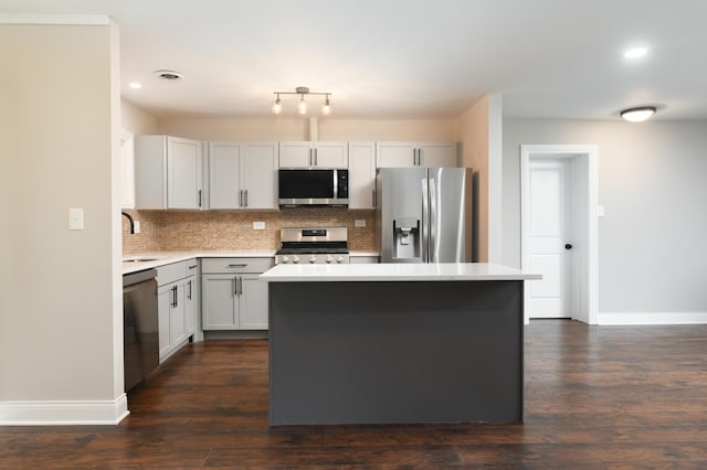 kitchen featuring white cabinets, a center island, sink, and appliances with stainless steel finishes