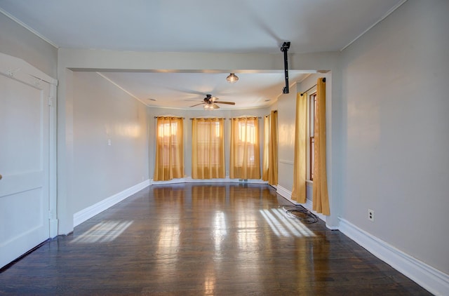 empty room with ceiling fan and dark wood-type flooring