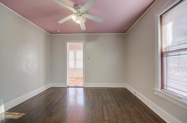 spare room with ceiling fan, ornamental molding, and dark wood-type flooring