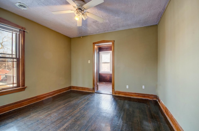 spare room with ceiling fan, dark wood-type flooring, and a textured ceiling